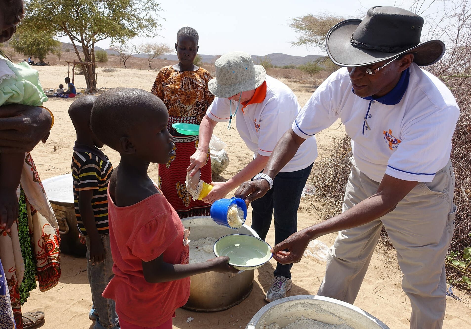 Charles Mulli serving food to children